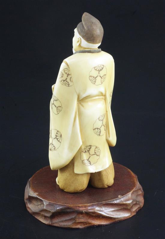 A Japanese ivory figure of a scholar, early 20th century, 11.8cm, wood stand